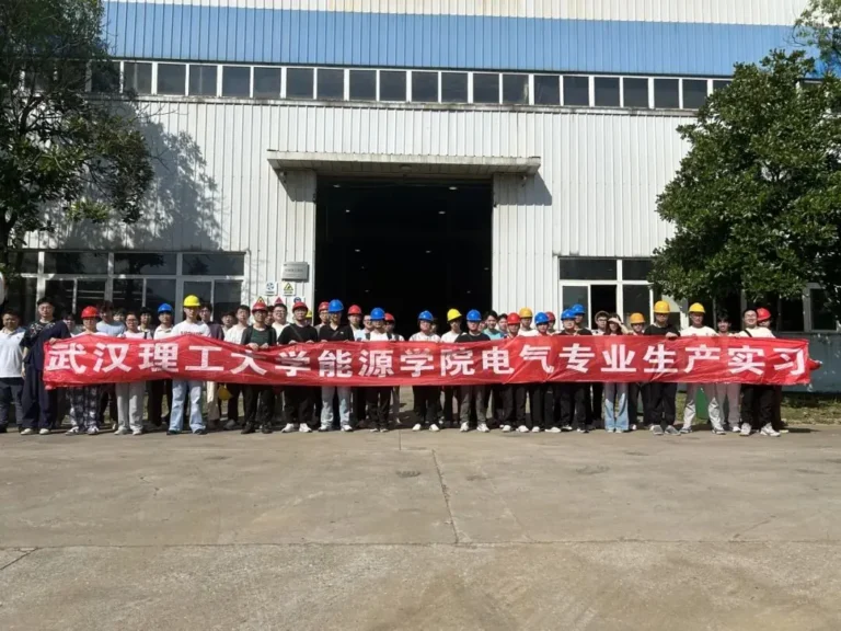 NSD Electric engineer explains an electrical control cabinet to Wuhan University of Technology students during their factory internship.